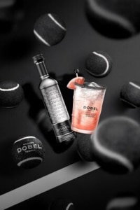 Maestro Dobel Diamante Tequila Bottle and an Ace Paloma in a 2024 US Open Branded Souvenir Cup